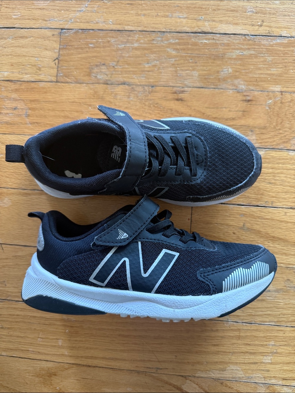 New Balance Kids Black and White Sneakers with Reflective Accents